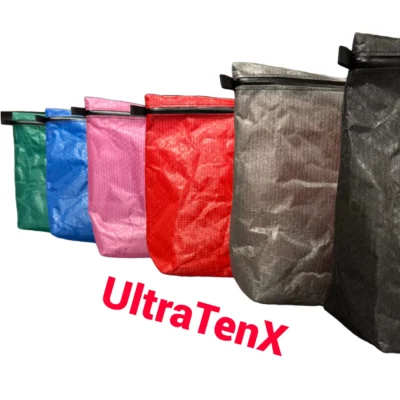 Row of colorful reusable shopping bags in green, blue, pink, red, and gray with 'UltraTenx' partially visible.