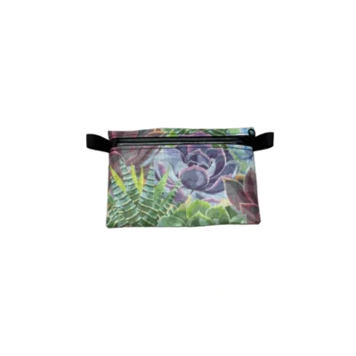 Colorful zip pouch with a succulent and plant print and black zipper and wrist strap