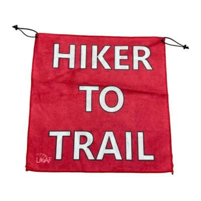Red drawstring banner with bold white text reading 'HIKER TO TRAIL'.